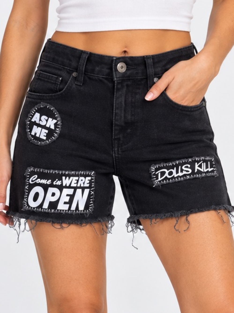 Dolls Kill black denim shorts raw-hem with text patches Dolls Kill logo, size M